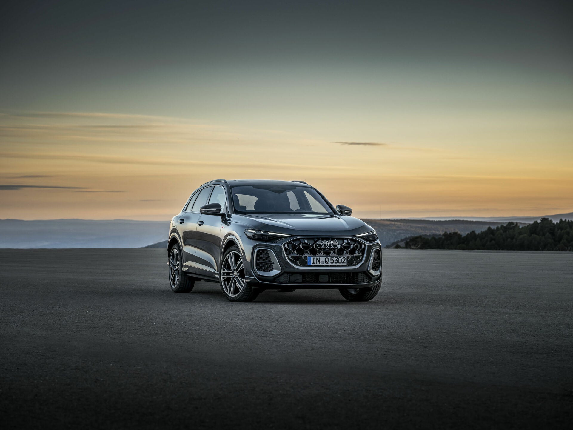 2025 Audi Q5 SUV parked in front of a large mountains